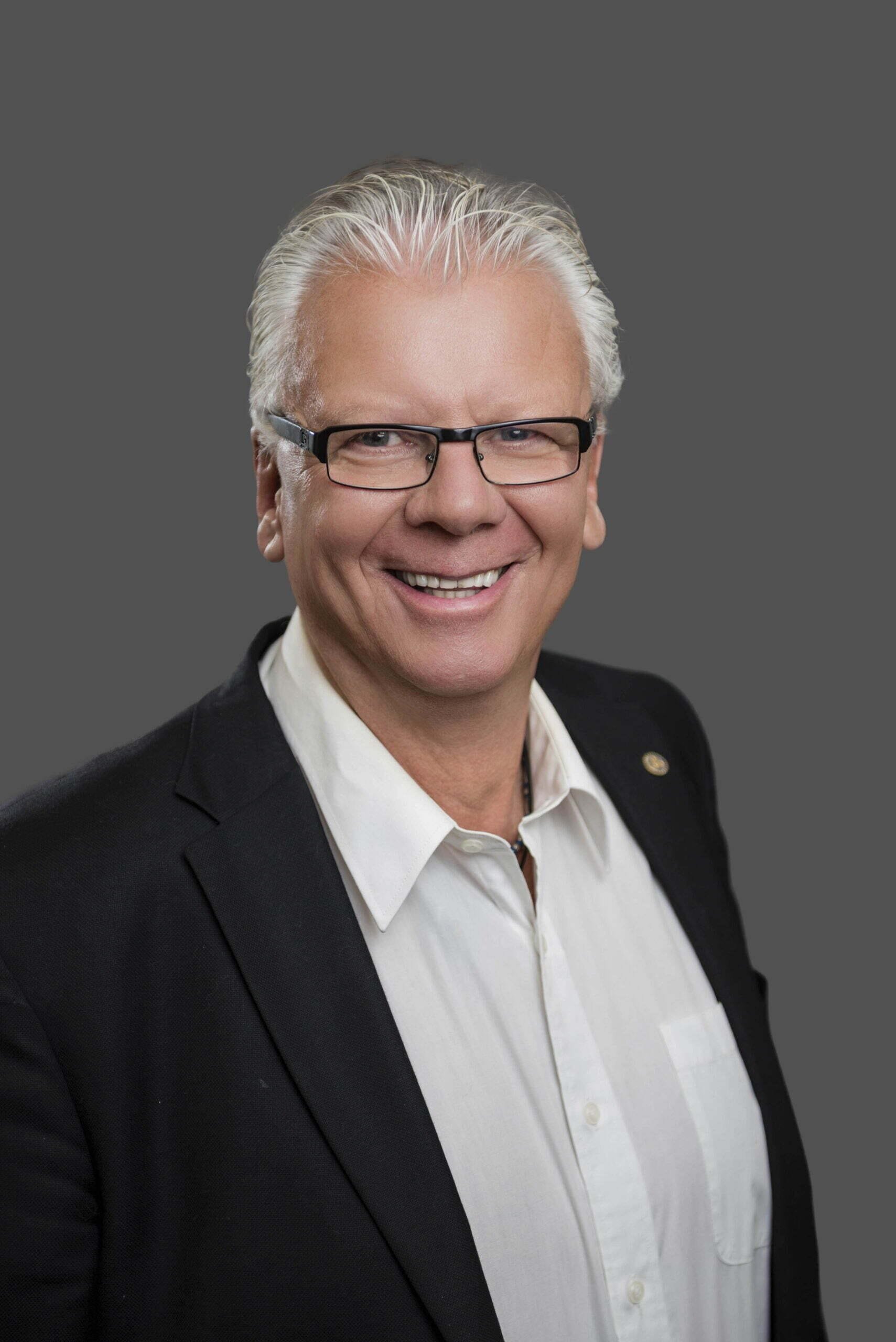 BC Liberals-13- Smiling man in suit and glasses