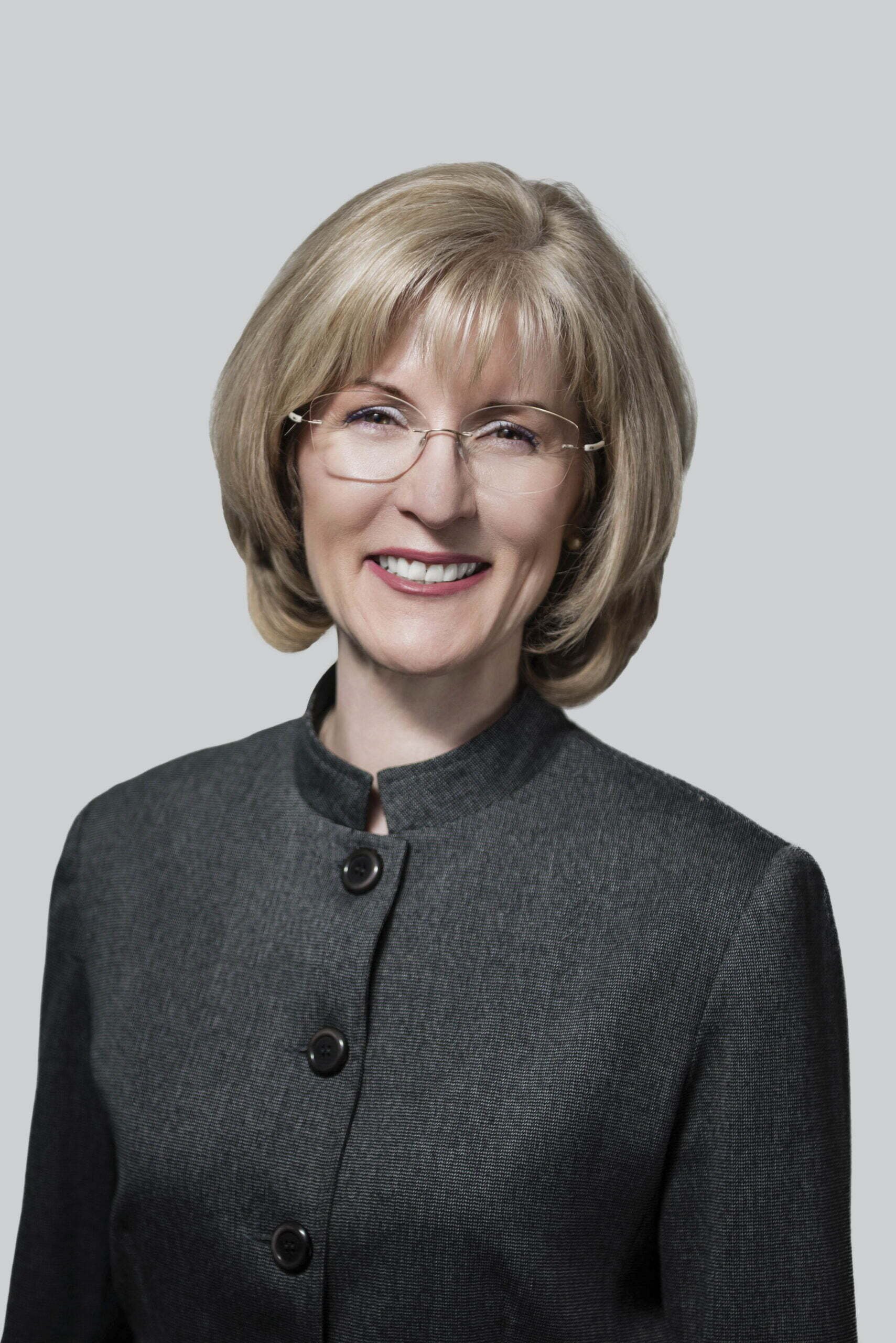 BC Liberals-2- Smiling woman in glasses and gray suit.