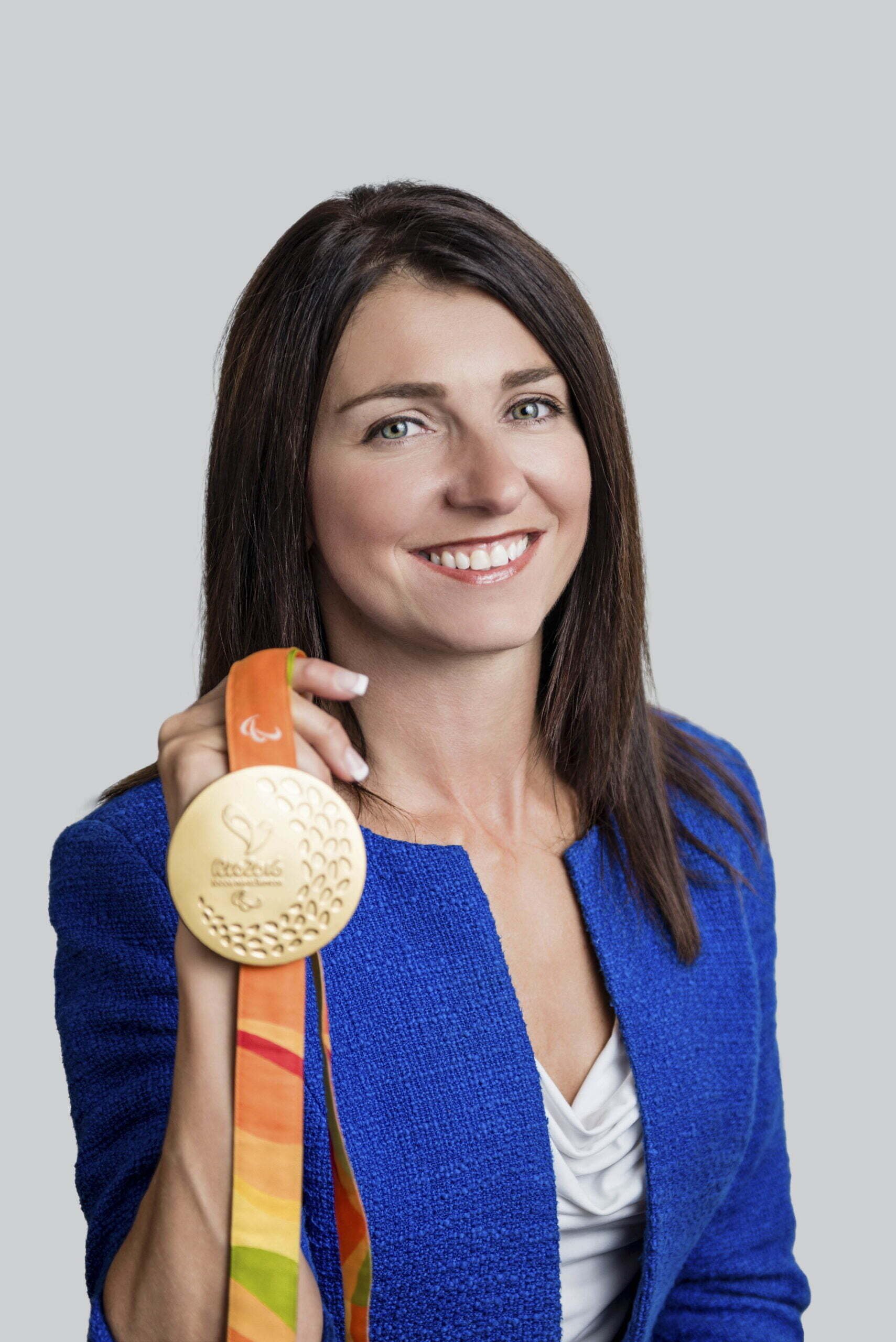 BC Liberals-8- Woman smiling and holding a gold medal