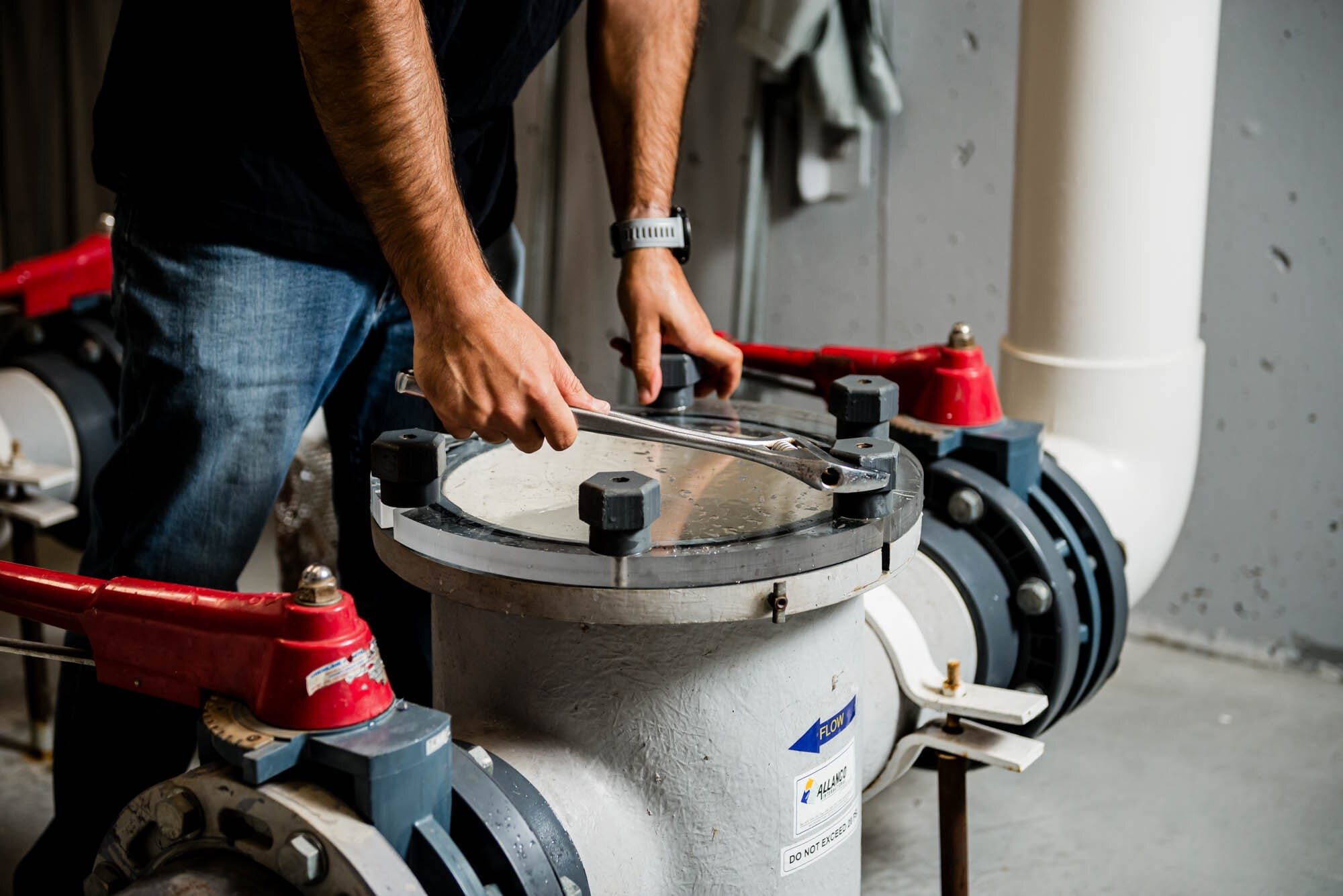 CoquitlamCityHR-1 Person using wrench on industrial pool filtration system