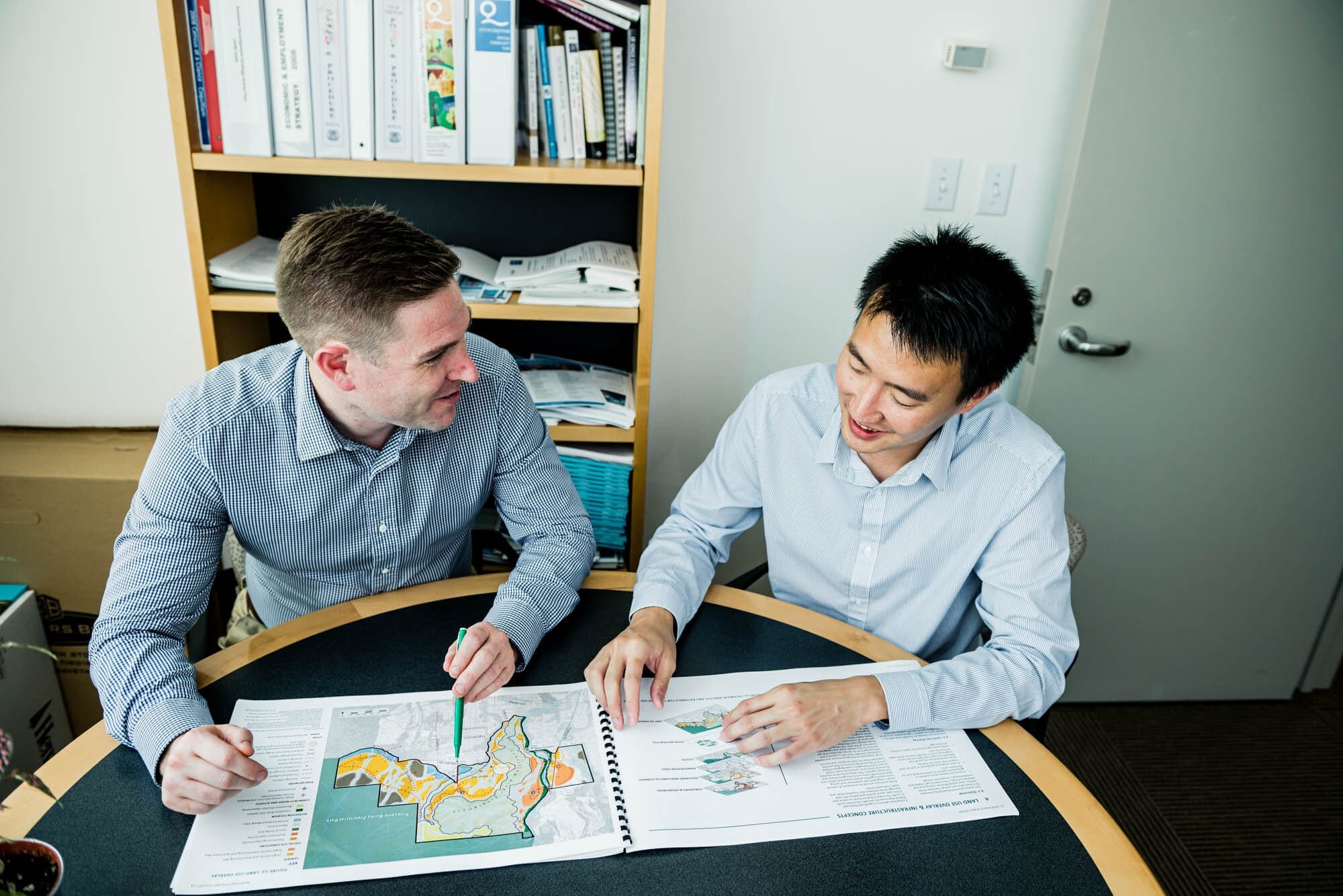 CoquitlamCityHR-10 Two colleagues reviewing maps and documents.