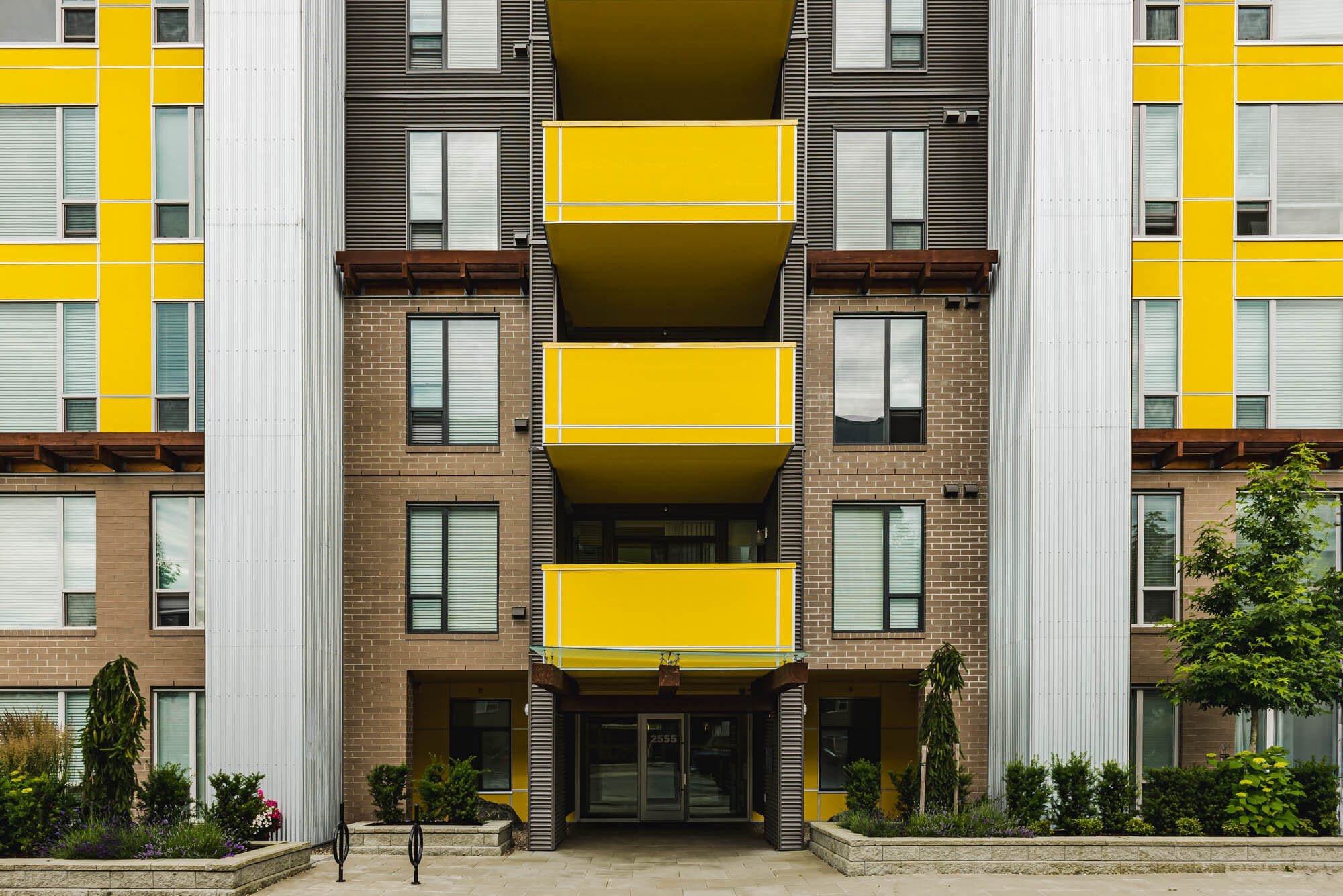 Cronus Masonry-3 Modern apartment building with yellow balconies