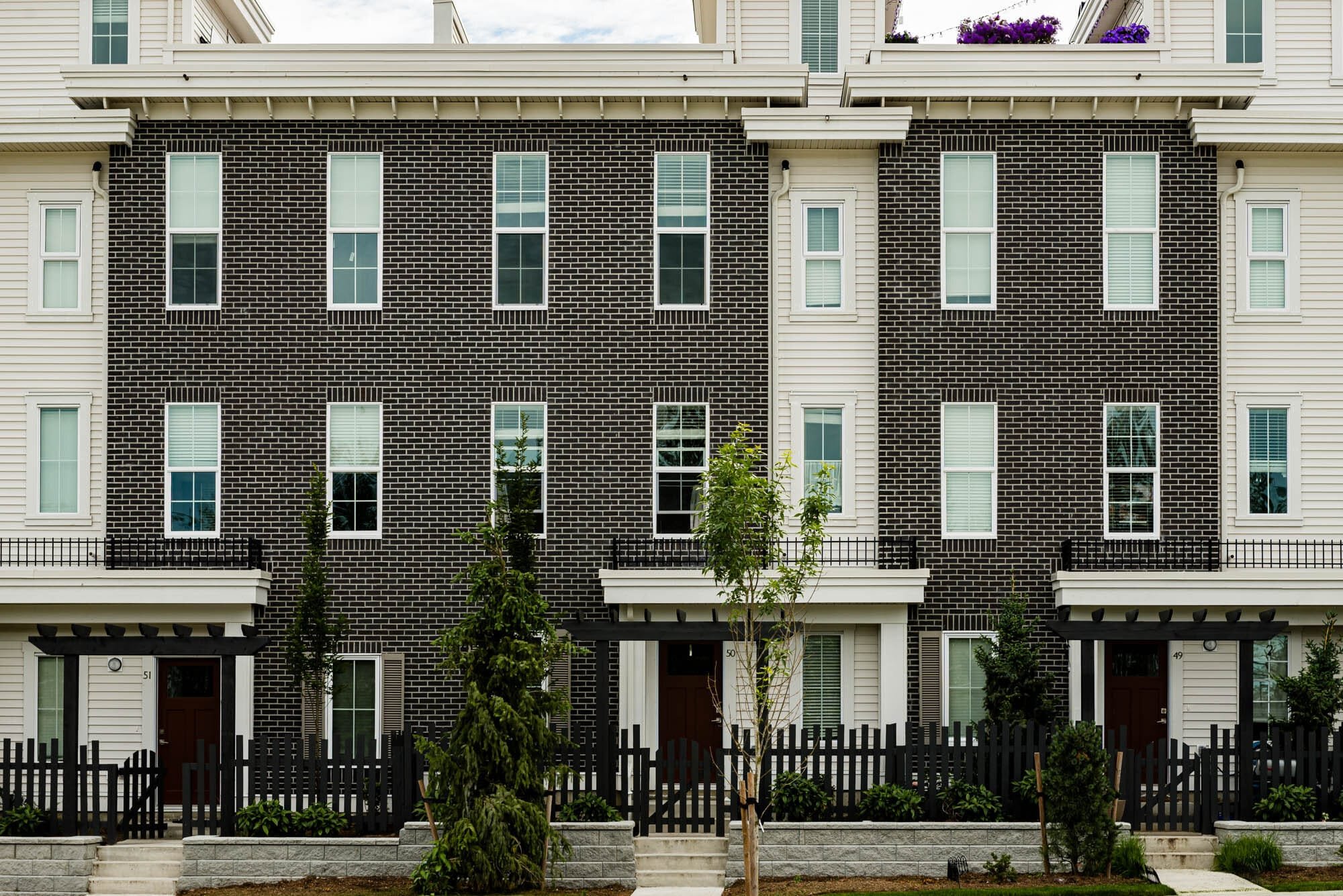Cronus Masonry-8 Modern townhouse exterior with black bricks and white siding