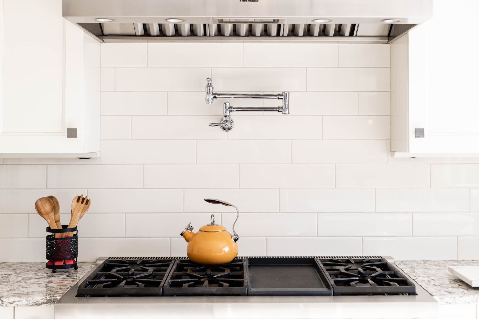 Modern kitchen with stove and kettle