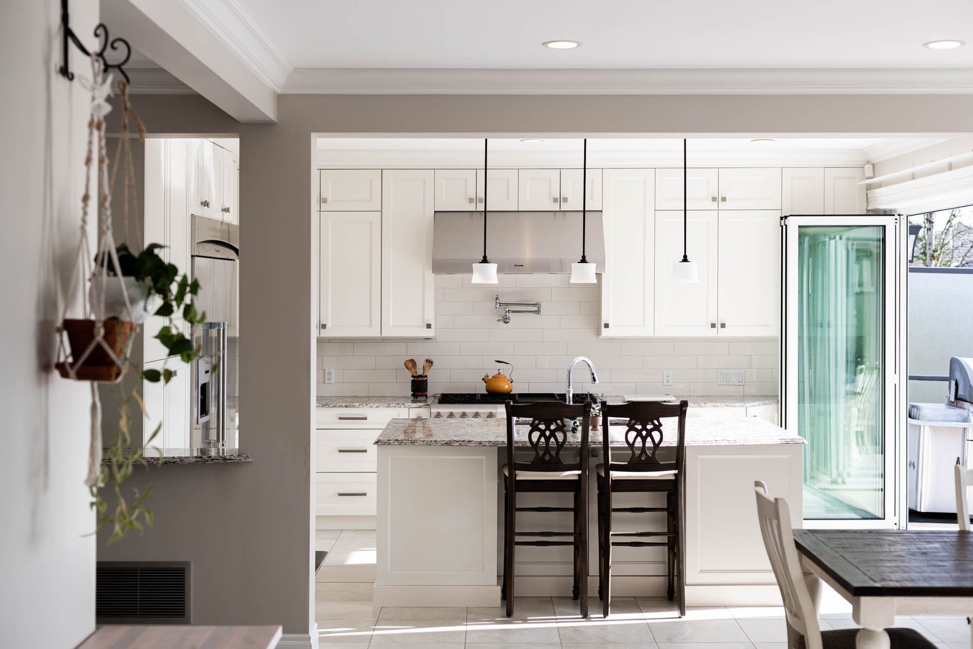 Modern kitchen with white cabinets and island.