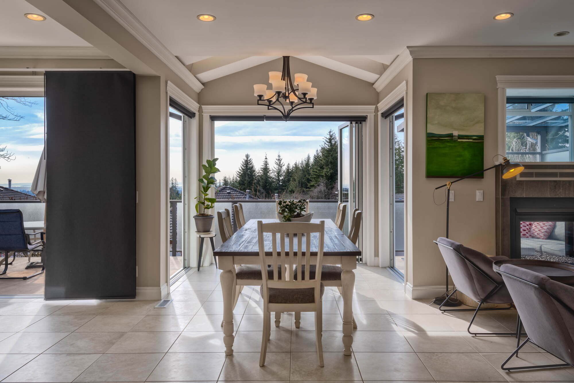 Modern dining room with large windows and forest view