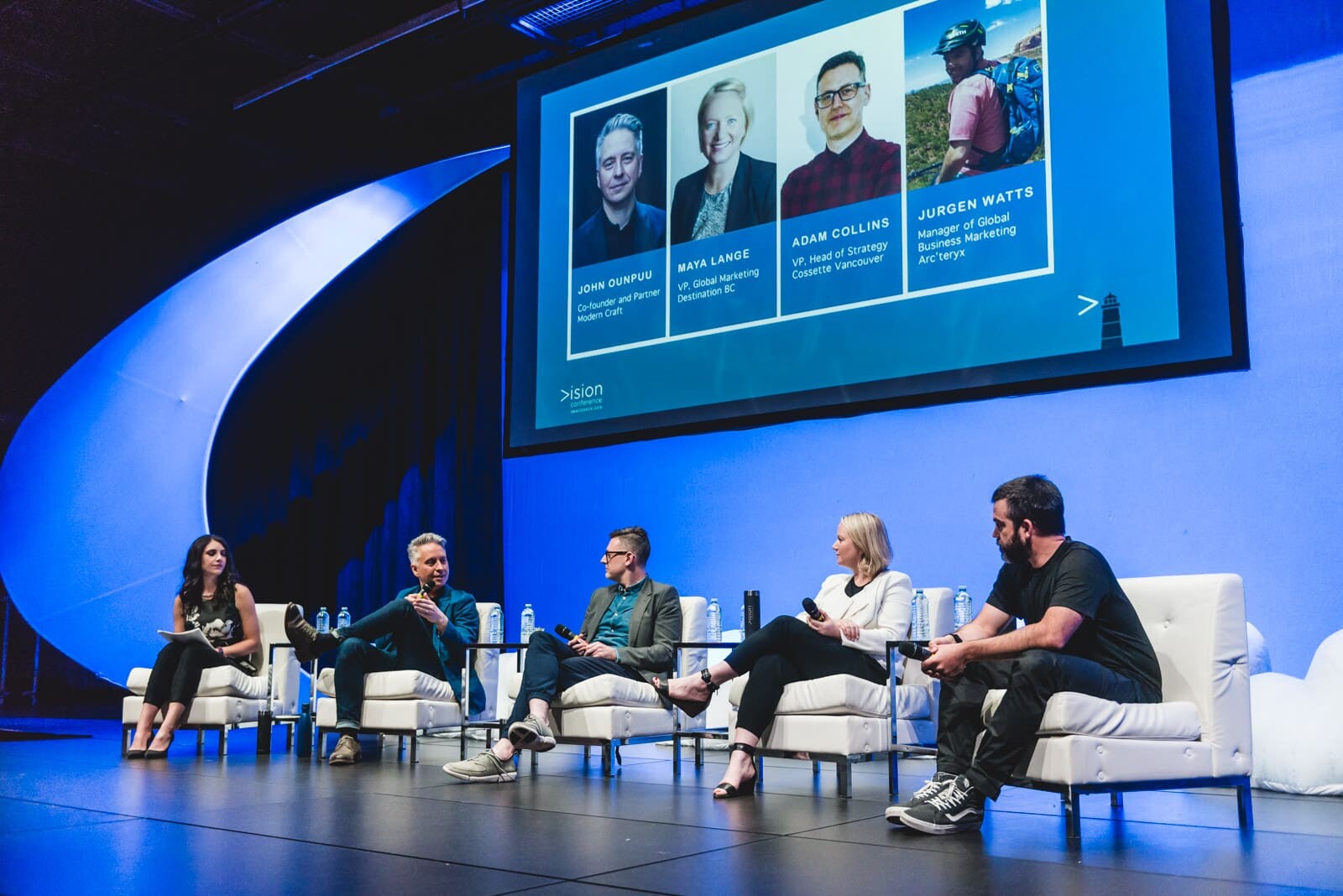 Panel discussion with five participants on stage.