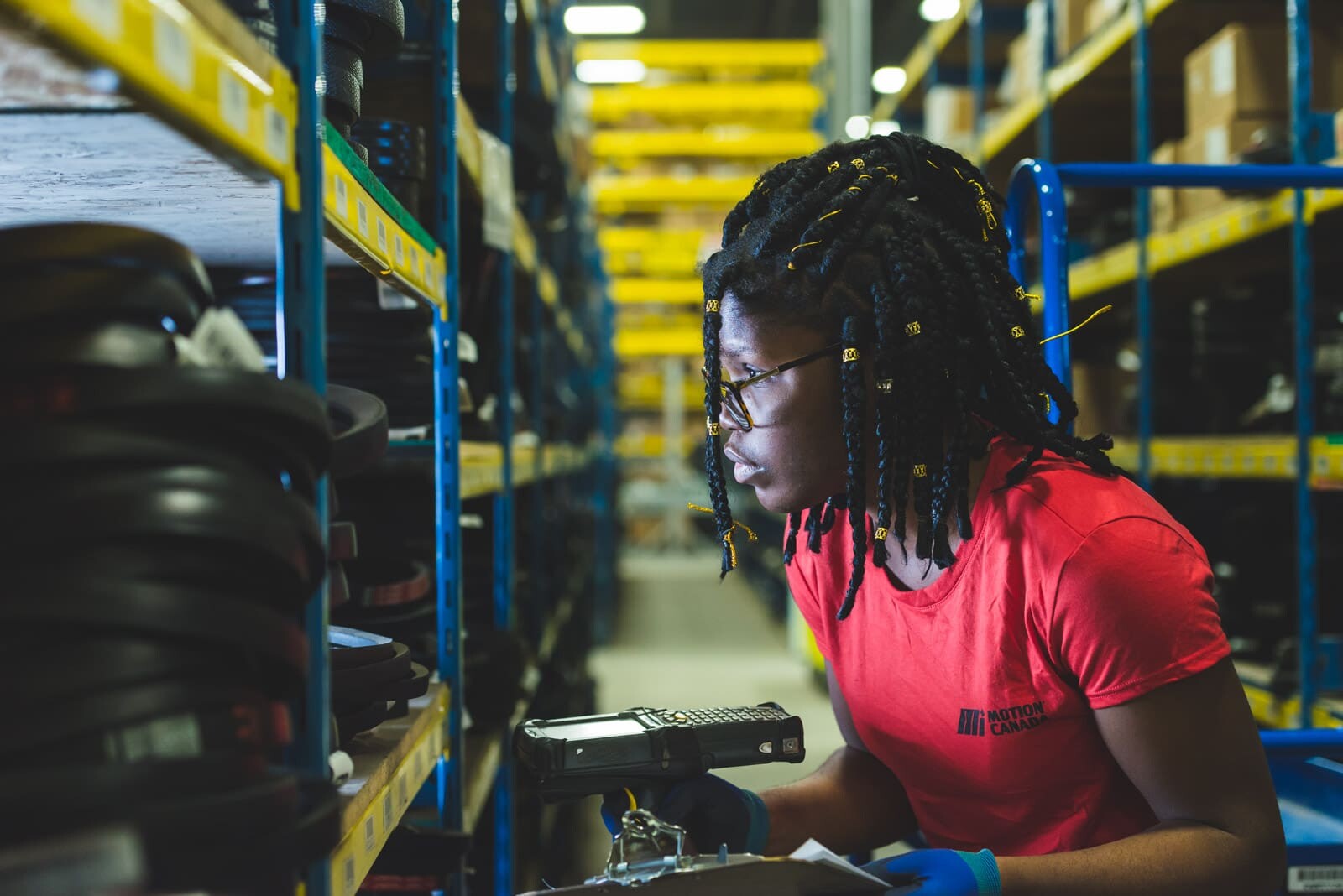 Warehouse worker scanning inventory shelves