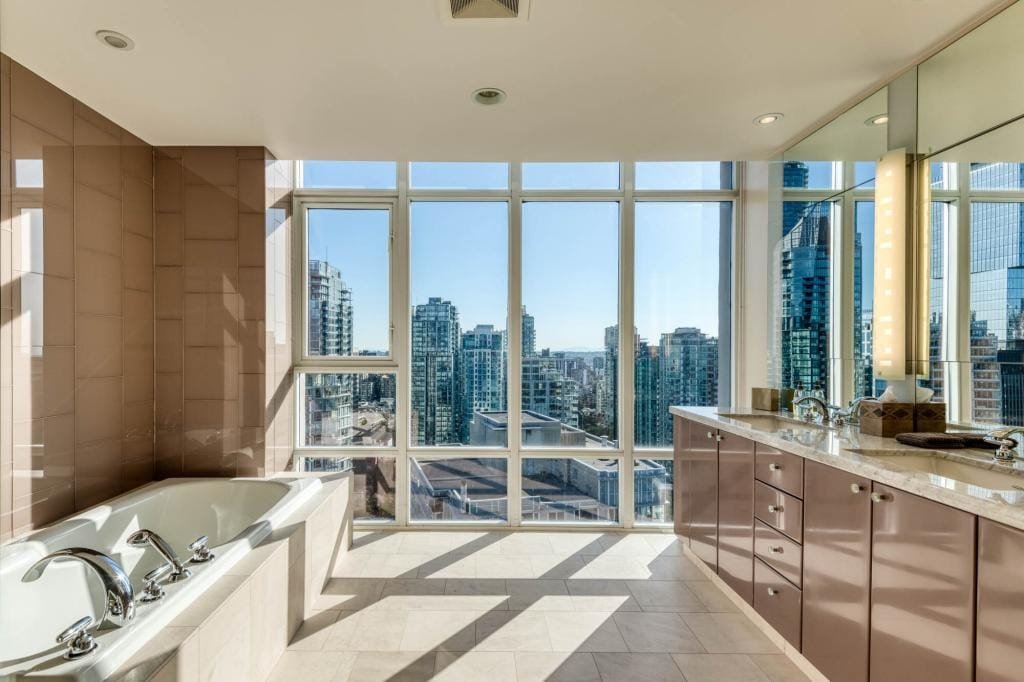 Modern bathroom with Vancouver city skyline view.
