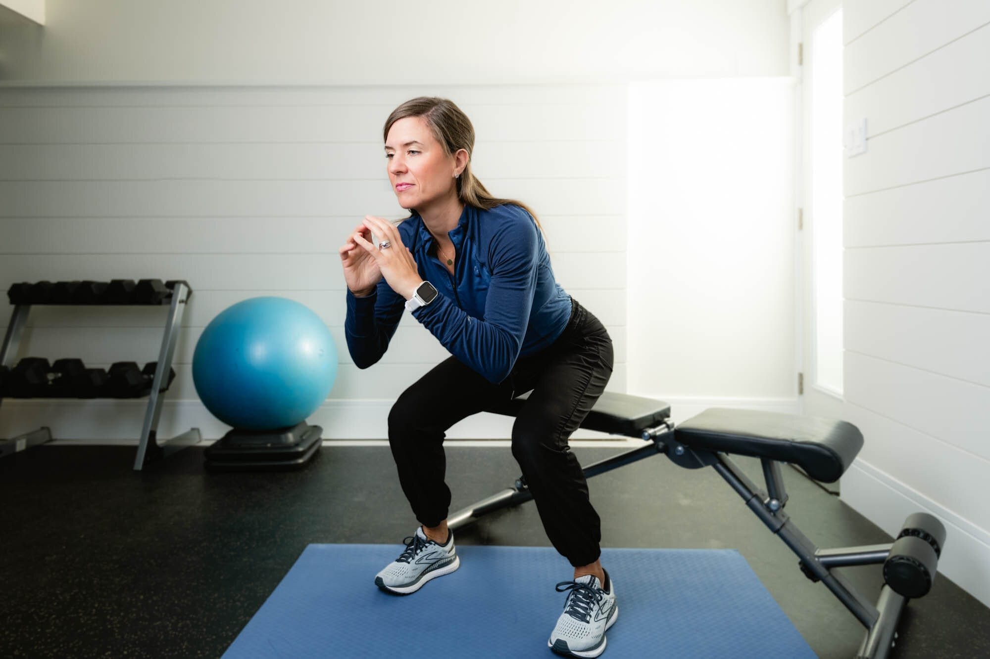 Strognerathome-2 Woman exercising, doing squats indoors