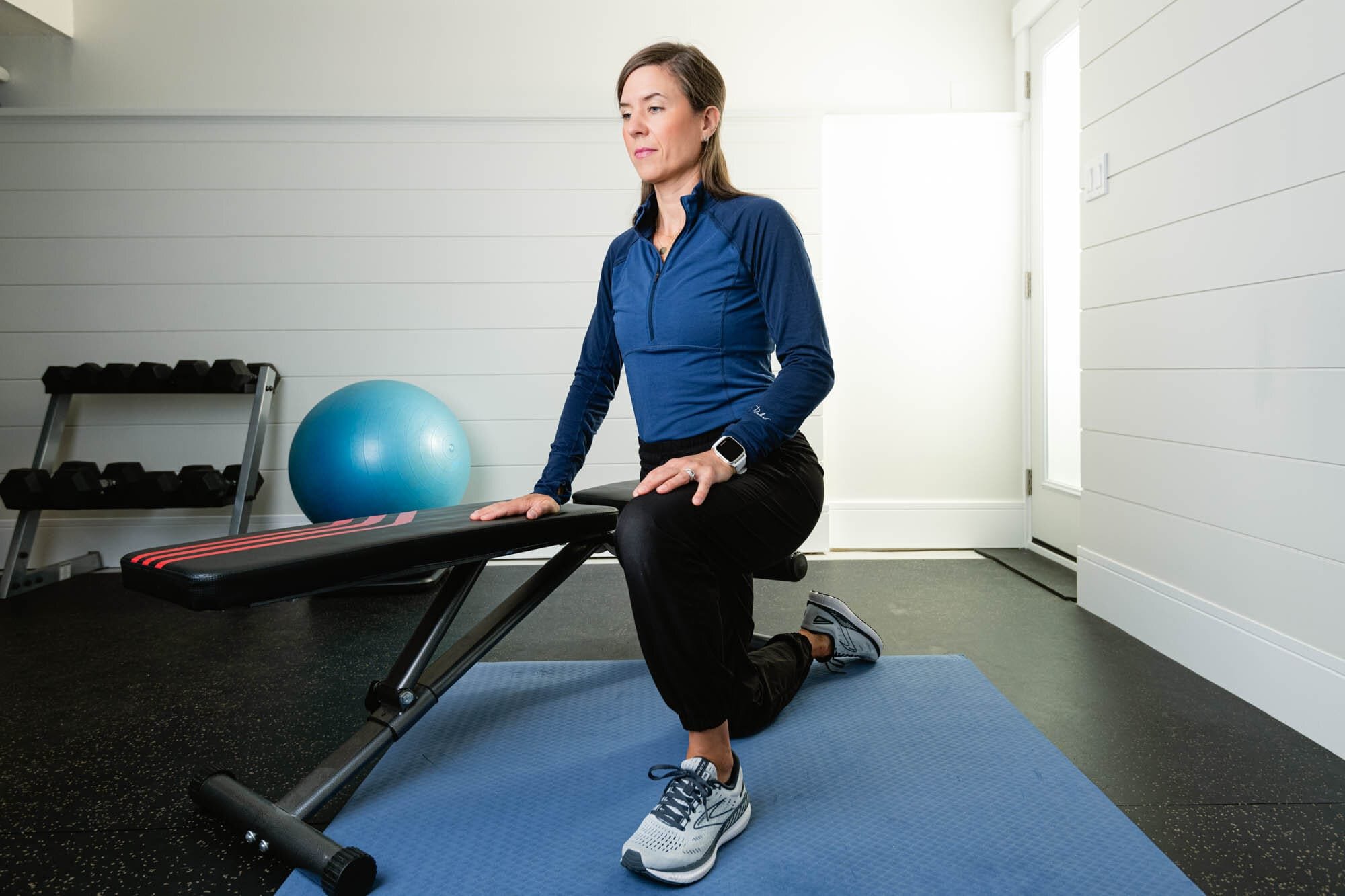 Strognerathome-3 Woman stretching on exercise mat in home gym