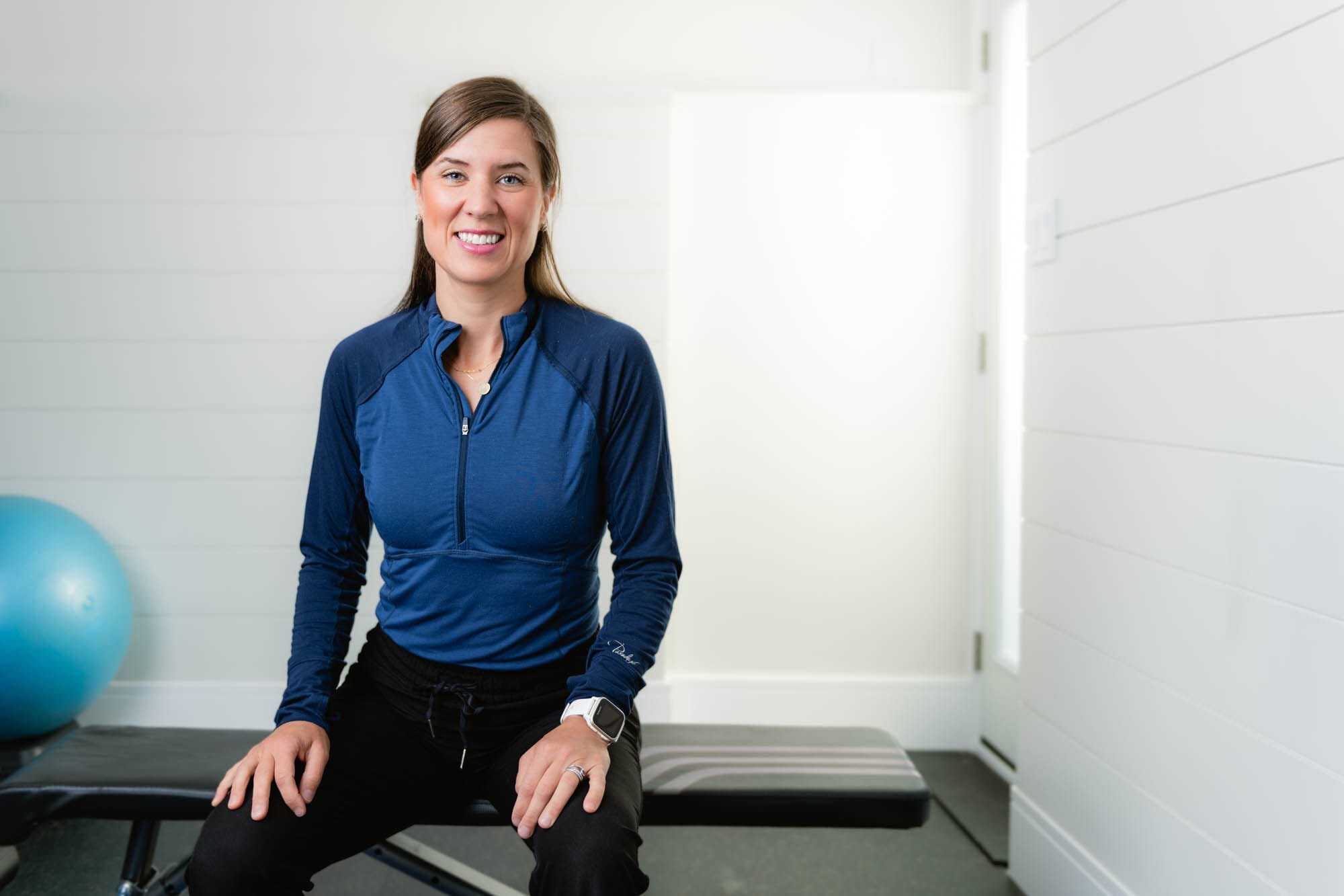 Strongerathome-2 Smiling woman in gym wearing blue workout top