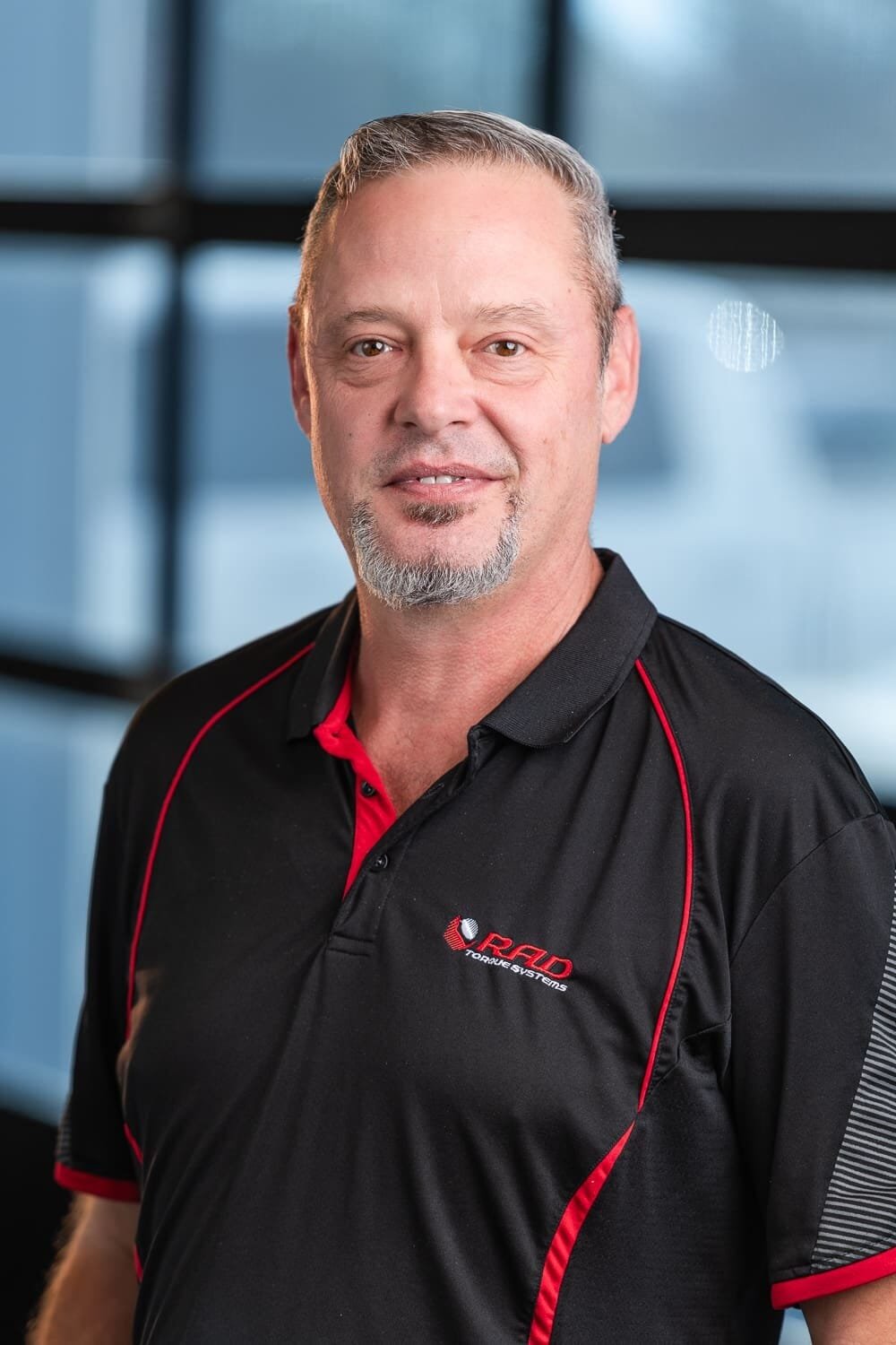 Rad Torque Web-2 Man wearing a black RFID Torque Systems polo shirt.