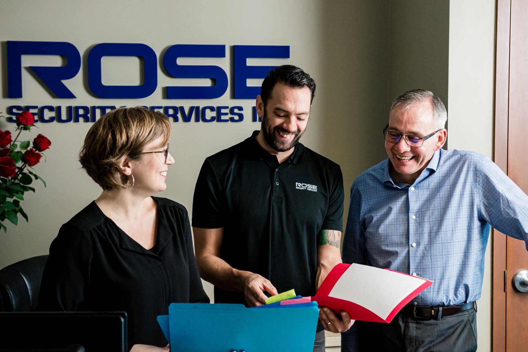 Rose Security-5 Rose Security Services team discussing documents.