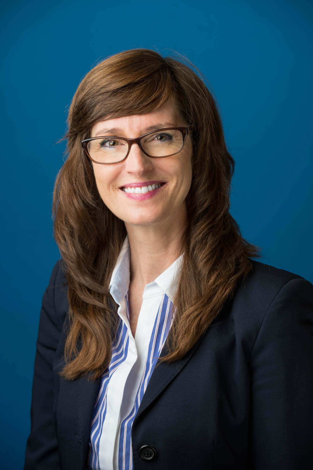 Rose Security Headshots-1 Smiling woman in business attire with glasses