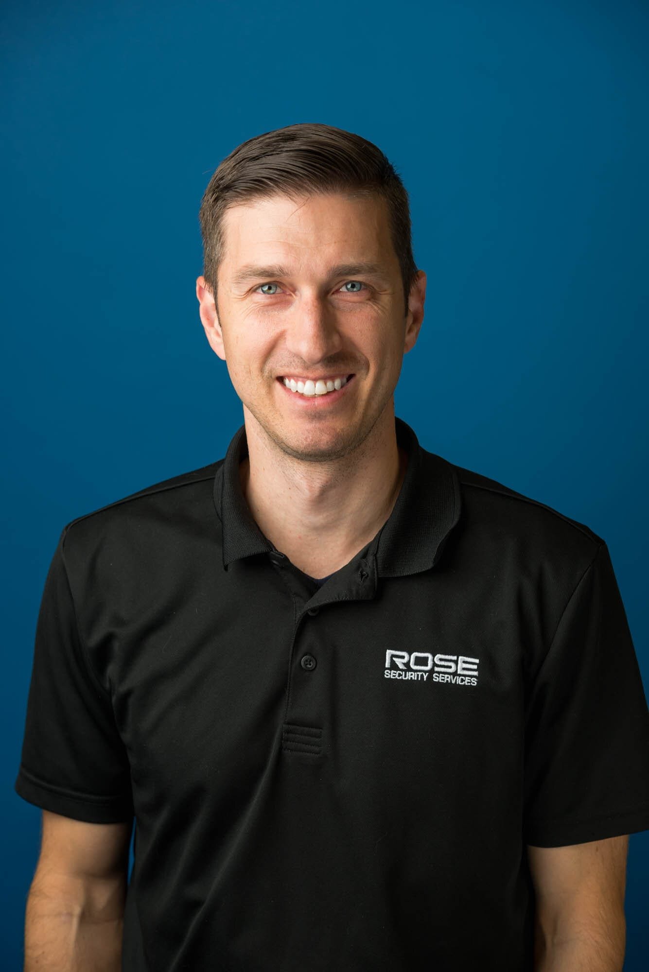 Rose Security Headshots-4 Man in black Rose Security Services shirt