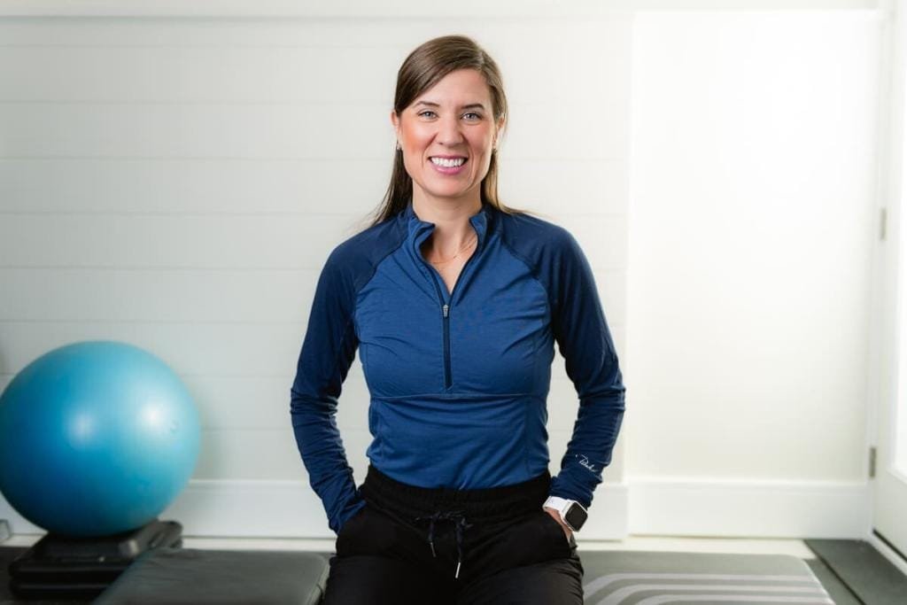 Woman in blue exercise attire smiling