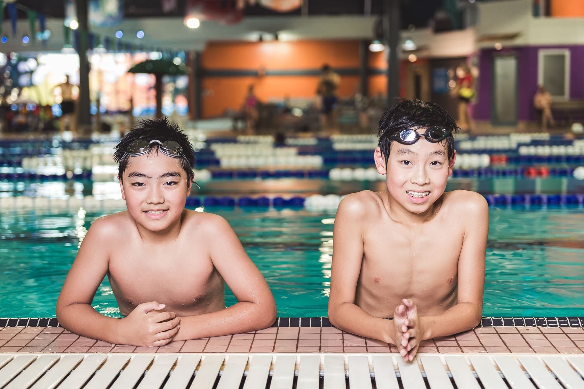 BAP_1347 Two boys smiling by indoor swimming pool