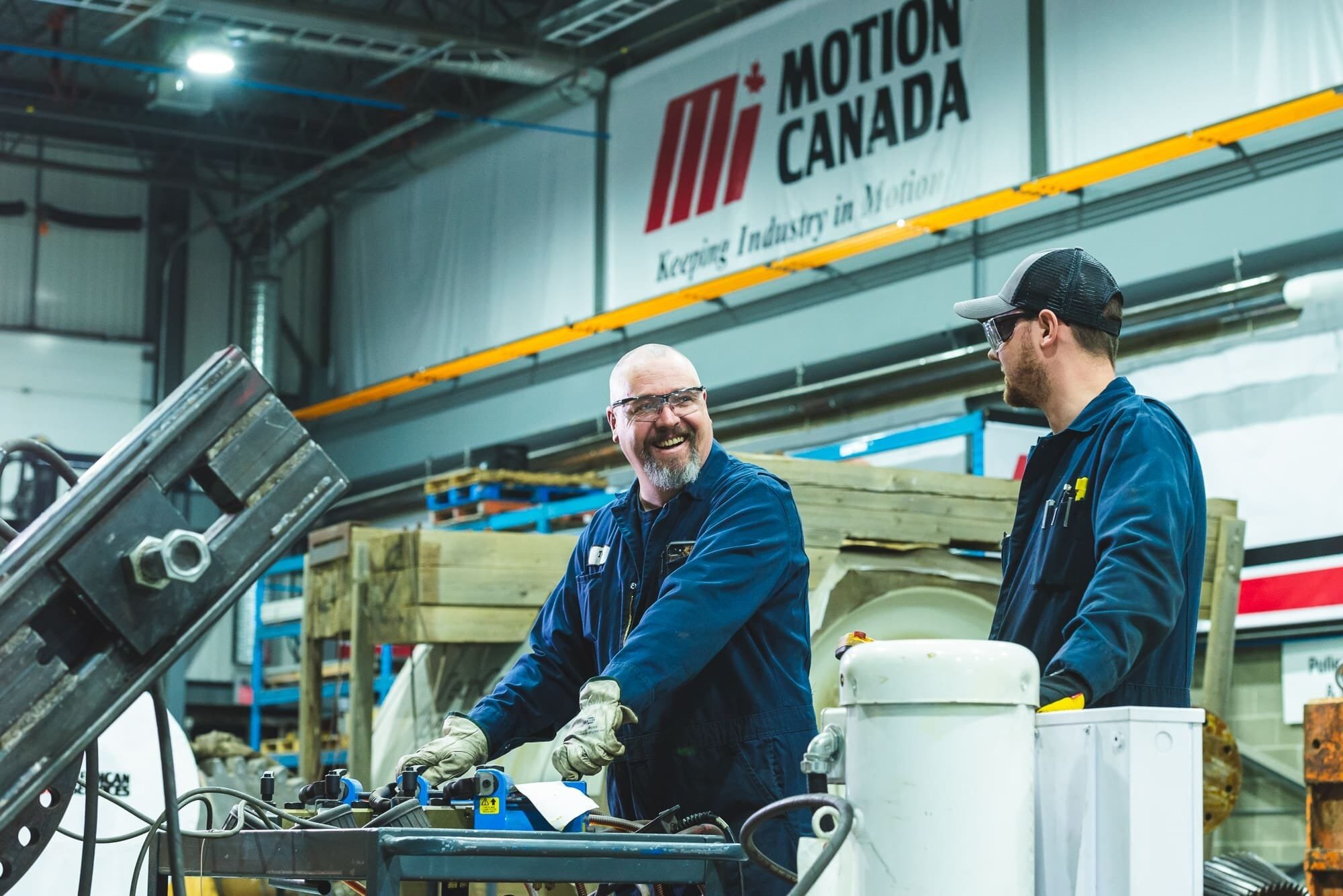 BAP_2428 Workers in Motion Canada facility, smiling.