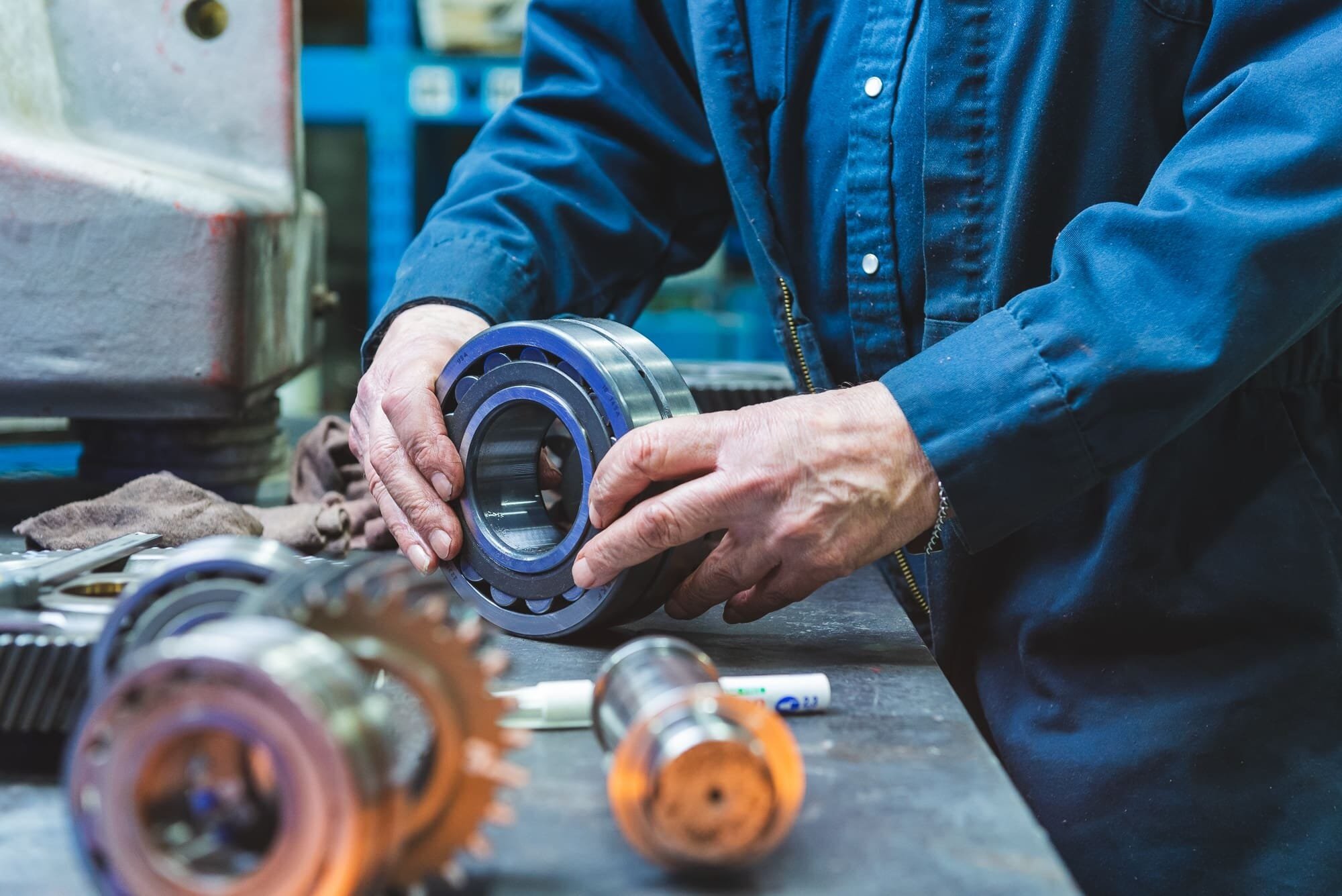 BAP_3656 Mechanic holding metal bearing in workshop