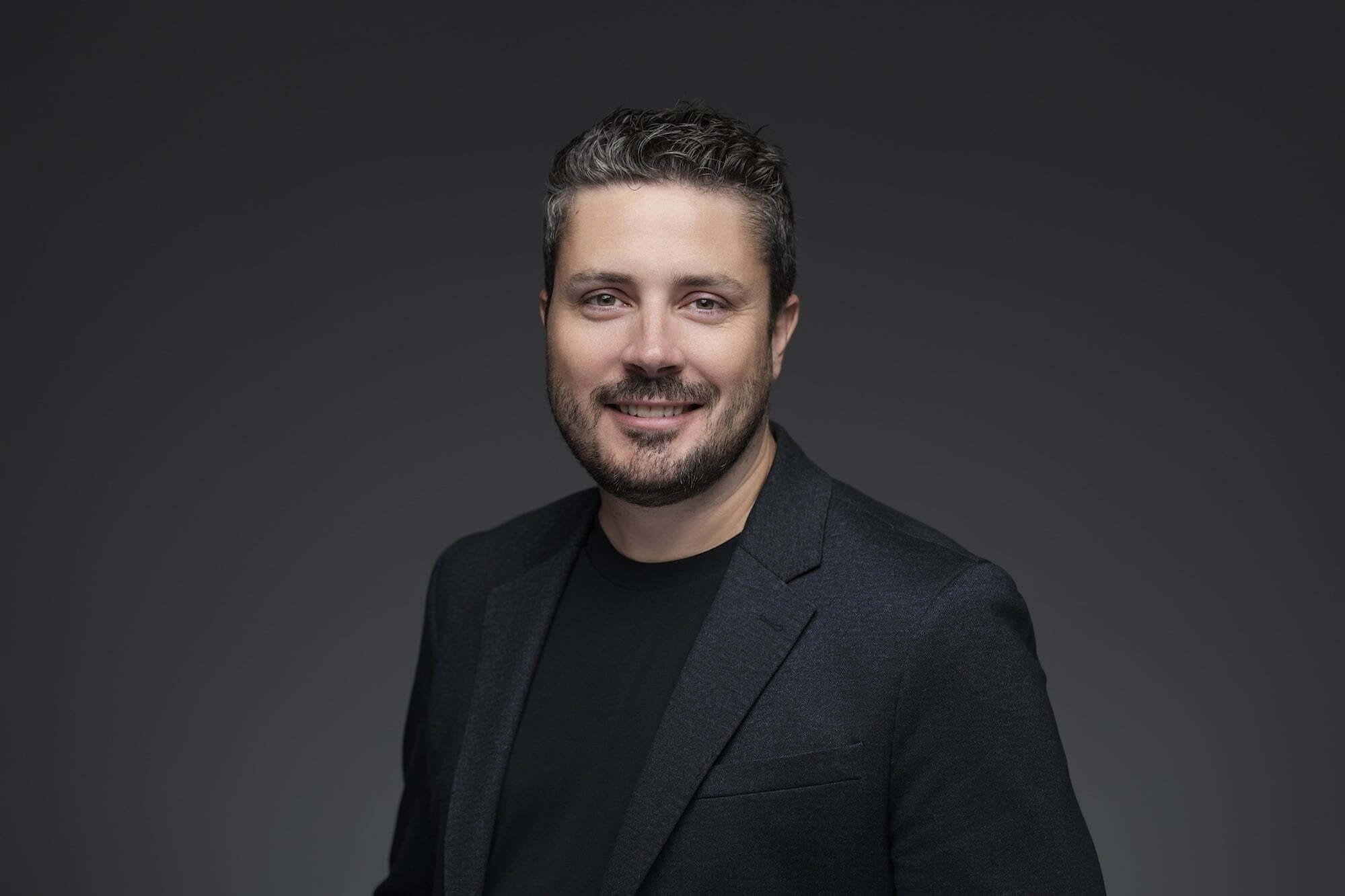 Cunningham_Evan_948-0500--retouched Smiling man in black blazer