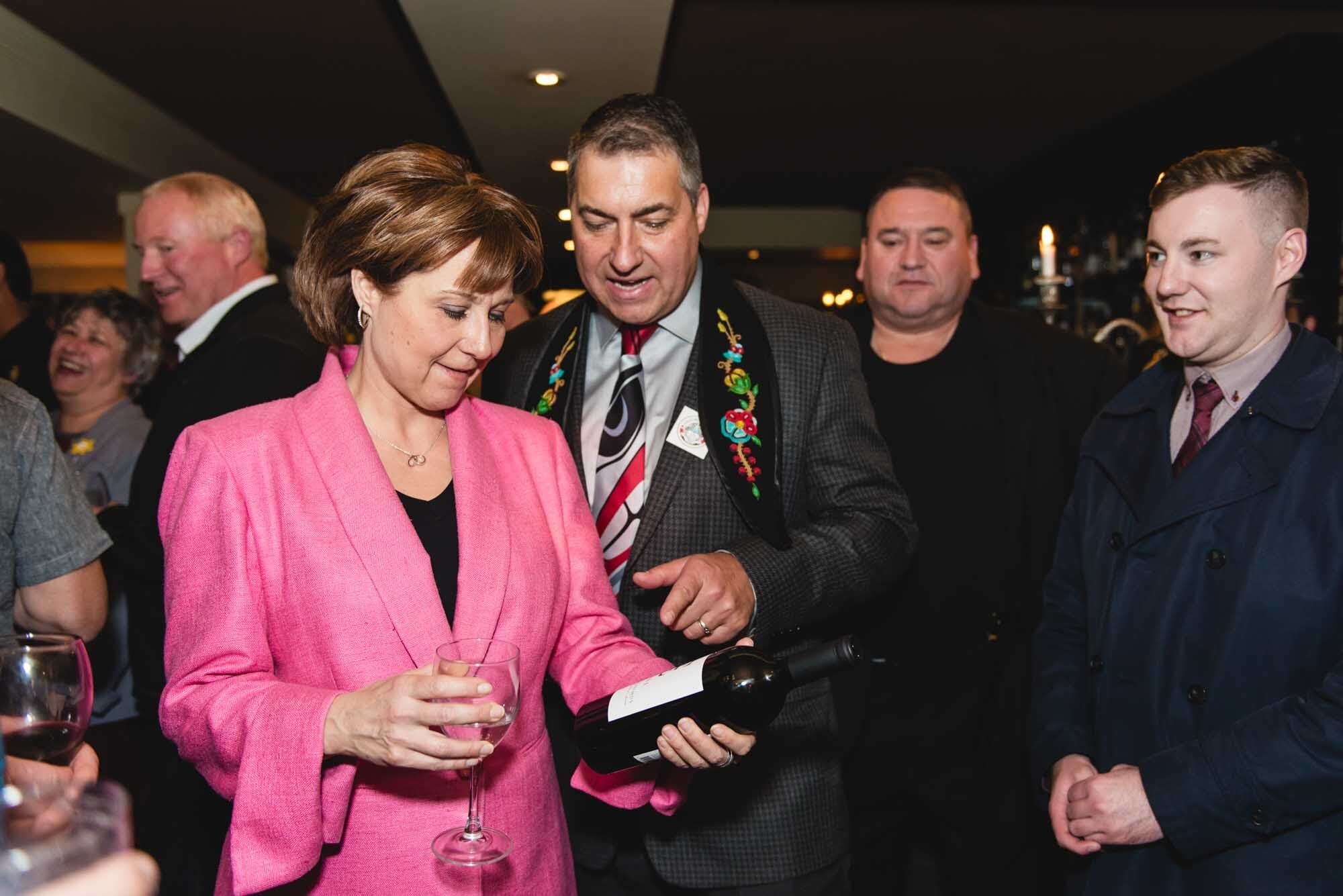 West Light Media Event Photography-18 Christy Clark at a fundraising event examining a wine bottle.