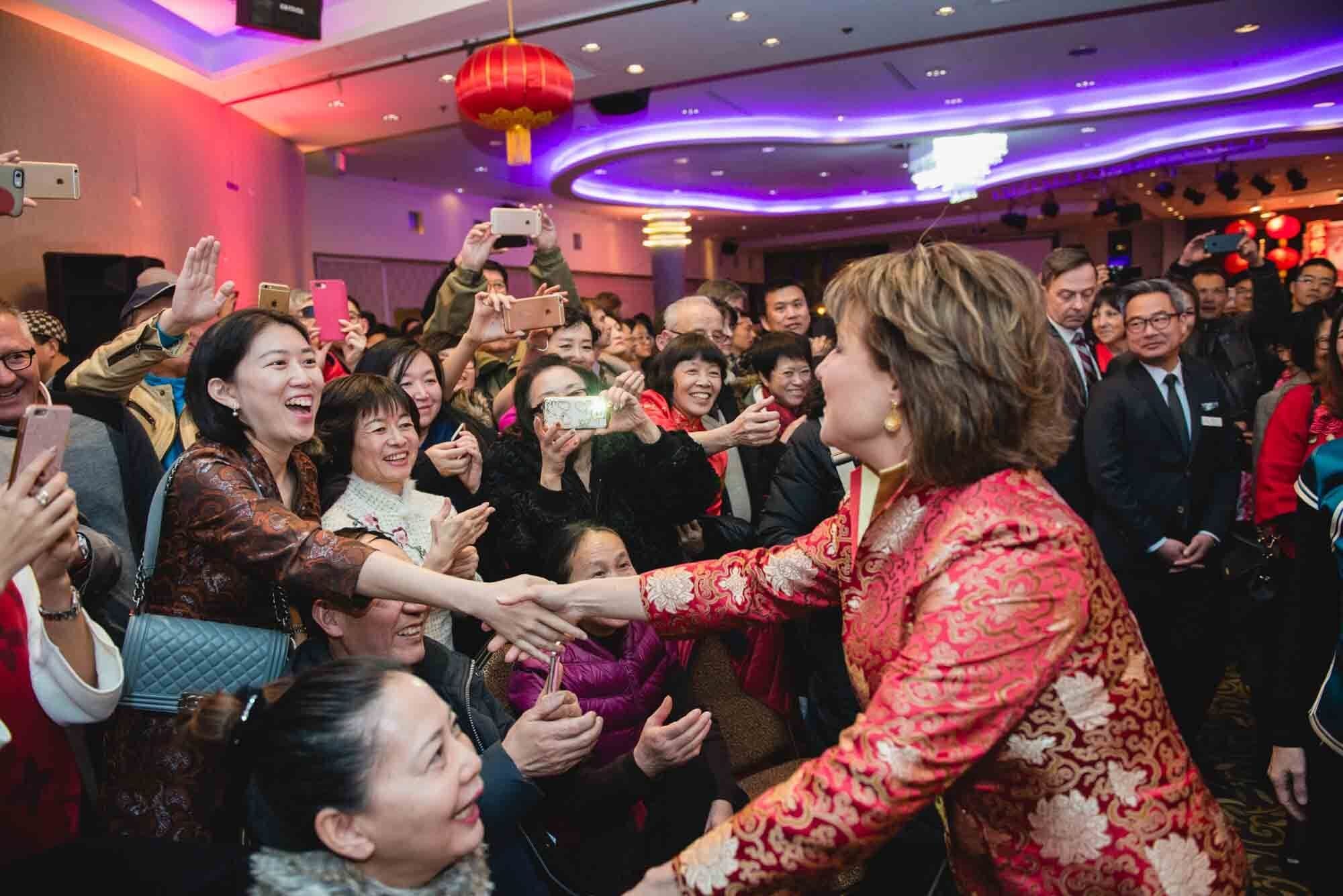 West Light Media Event Photography-32 Christy Clark in red greeting a crowd at an event.