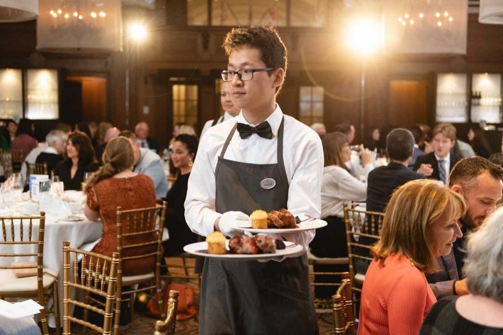 Waiter serving food at a formal event