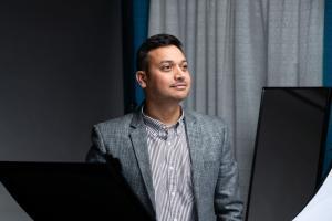 Man in gray suit posing at the headshot booth