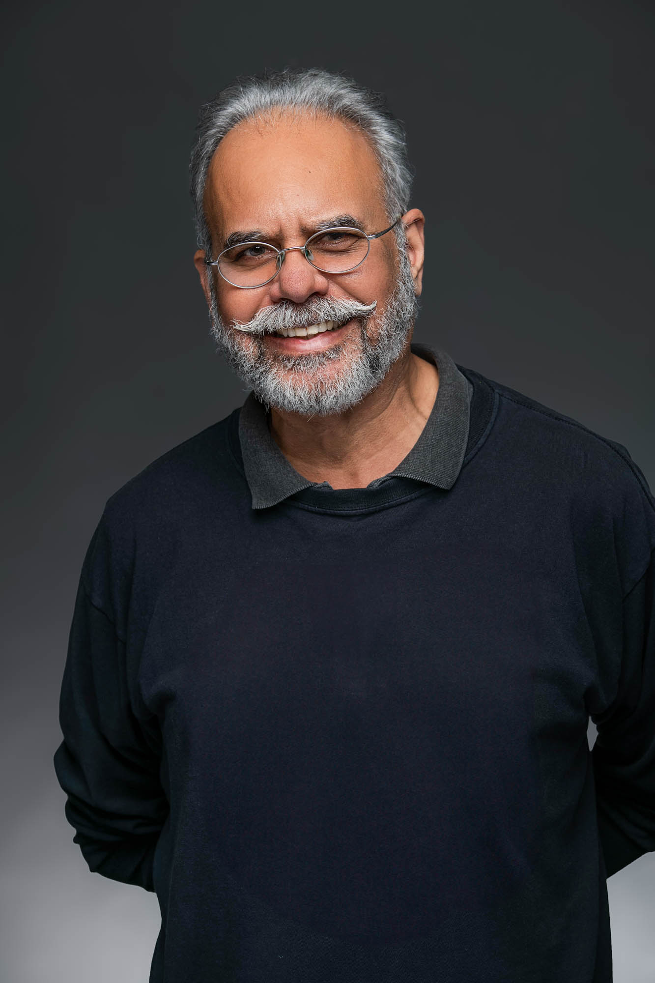 Smiling man with glasses and a beard.