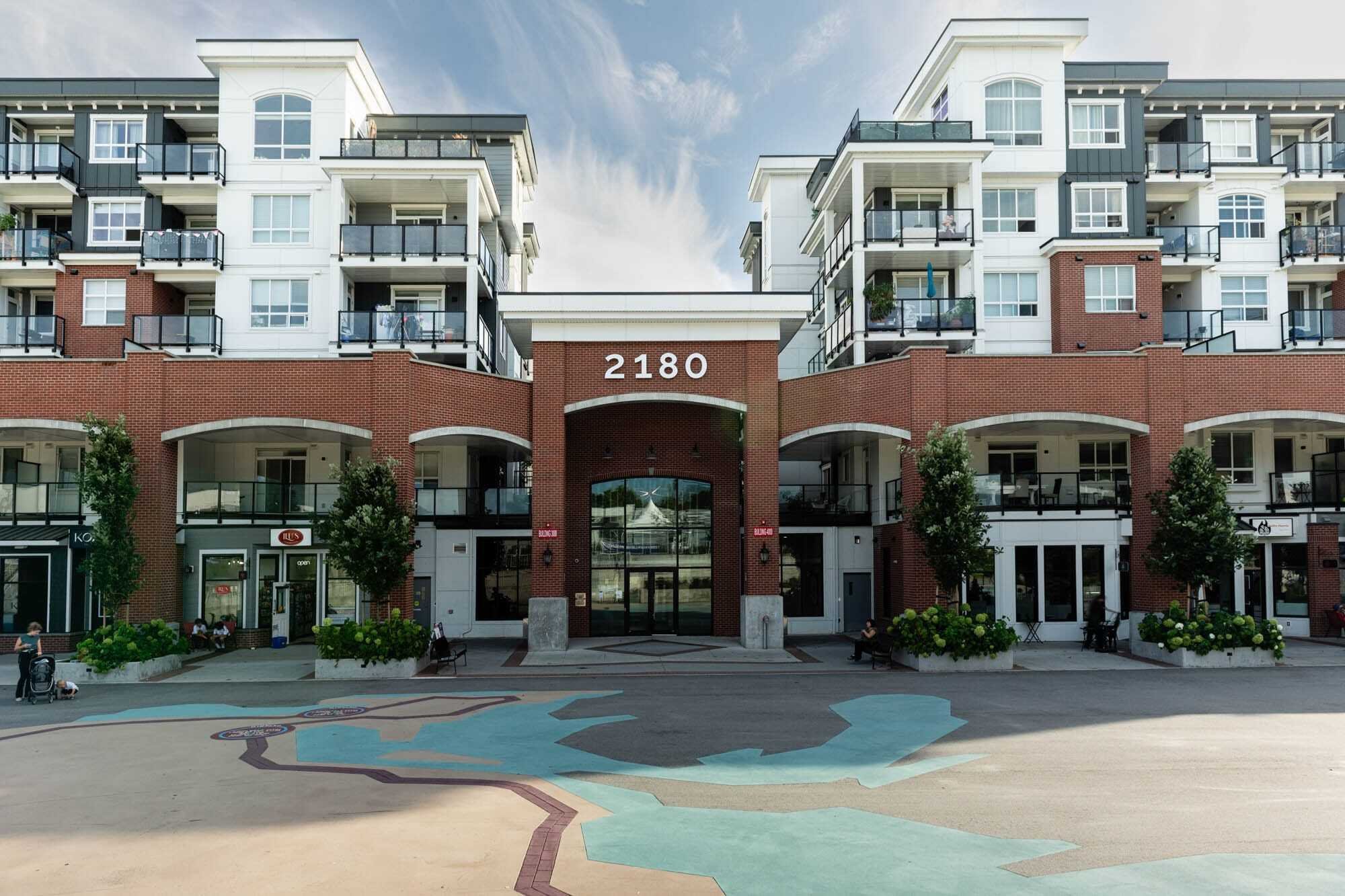 Jolt Charging-2 Modern apartment complex with brick facade and balconies.